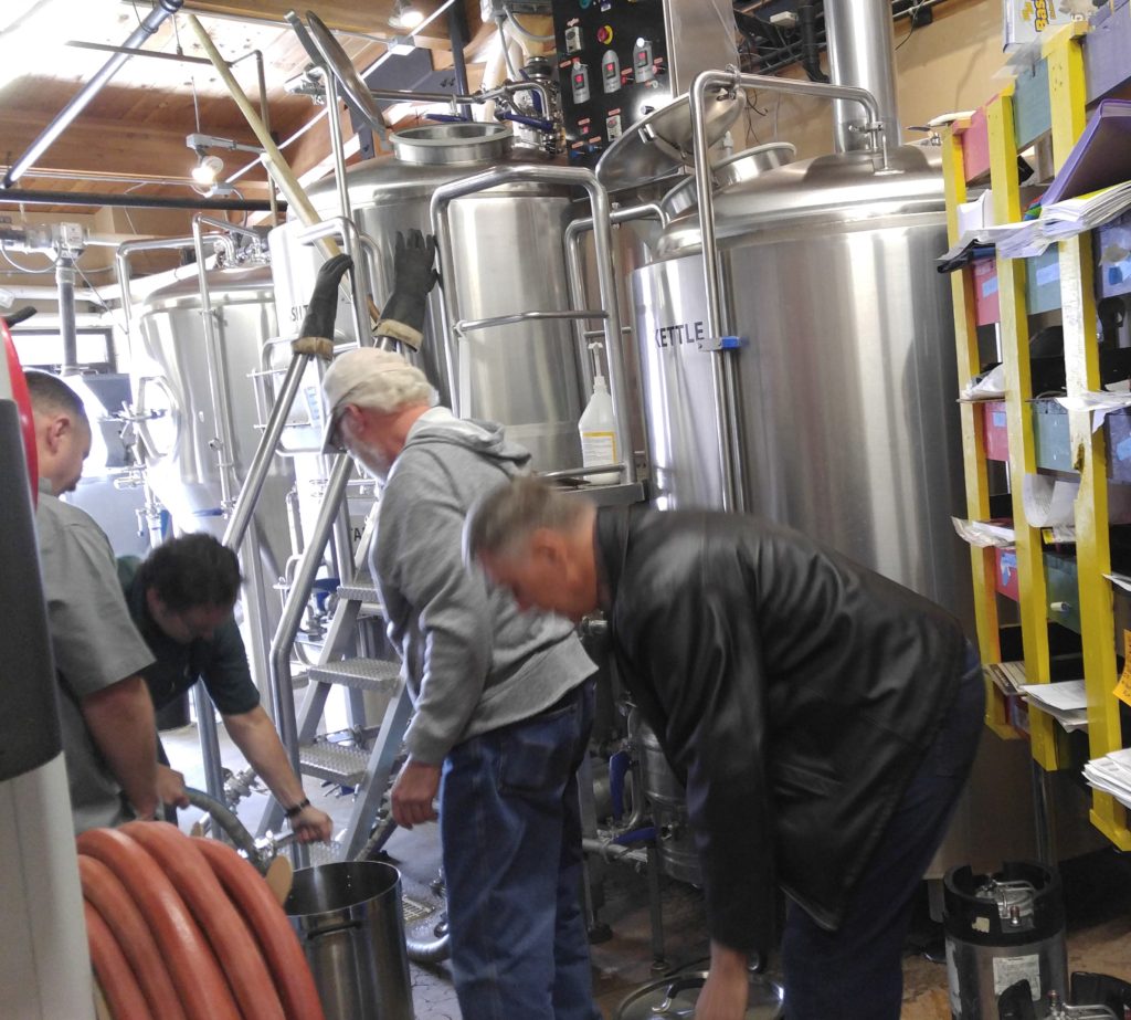 Chris filling up Homebrewer's kettles with delicious Wort.